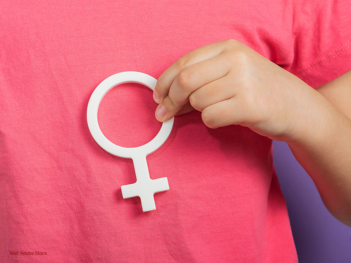 Gender symbol of a woman. Banner with woman symbol in hands on purple background with copy space. The concept of female discrimination, lesbian, leadership or domestic violence protest